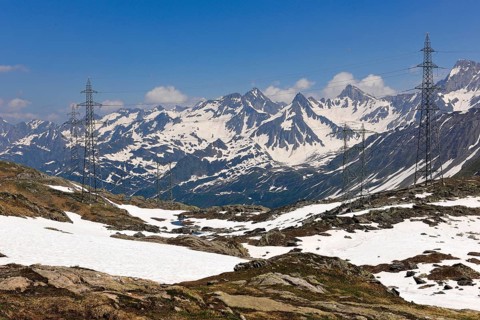View of power pylons overhead power lines power supply in high mountains