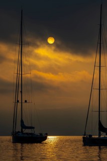 Sailing yachts anchored at sunrise in Portofino Bay