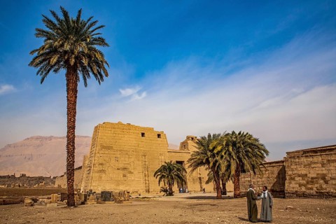 1st pylon in the funerary temple decorated with oversized relief depictions showing the pharaoh in typical displays of power slaying enemies in front of a deity