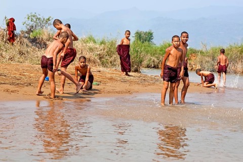 Bathing monks on the banks of the Nam Pilu River