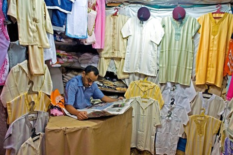 Vendor reading a daily newspaper