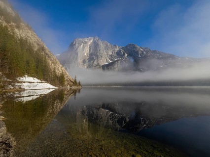 Fog lifts in front of the Trisselwand