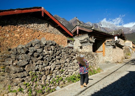 A resident carries brushwood home