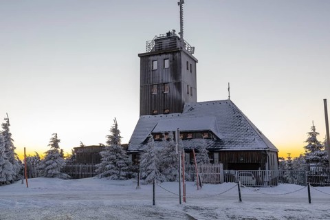 Snowy weather station with arches of lights on the summit of the Fichtelberg