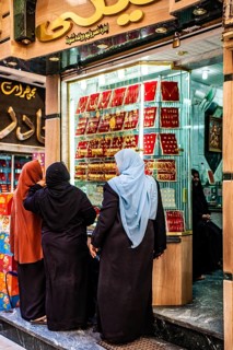 Women in front of displays of a gold jewellery shop