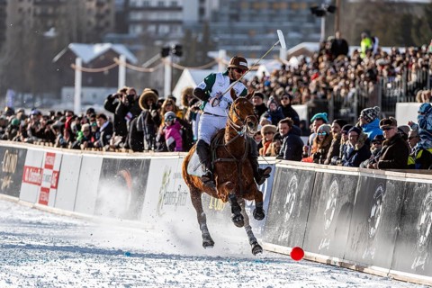Spectators watch Santiago Marambio of Team Azerbaijan Land of Fire trying to control the ball at the rail