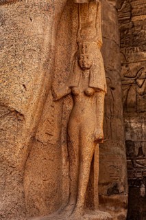 Figure of the Royal Wife Nefertari on the right leg of Ramses II. Luxor Temple