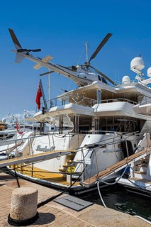 Luxury yacht with helicopter on deck anchored in the harbour of Saint Tropez