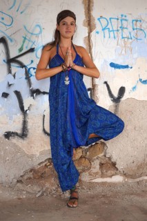 Young woman with headband doing yoga exercise and standing on one leg