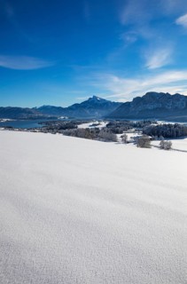 View of snow-covered Mondseeland with Schafberg and Drachenwand