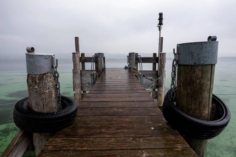 Empty shipping pier in autumn rain