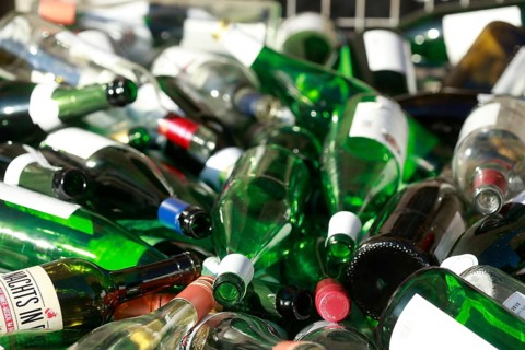 Empty wine bottles in a waste glass container