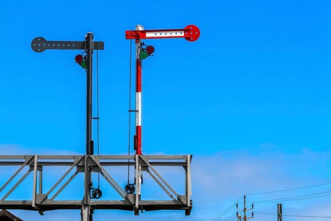 Railway signal against a blue sky