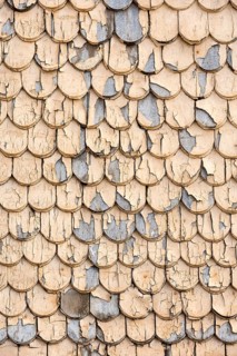 pattern of old wooden shingles with peeling paint