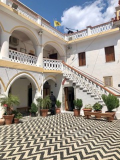 Greek Orthodox clergyman in the courtyard of a monastery