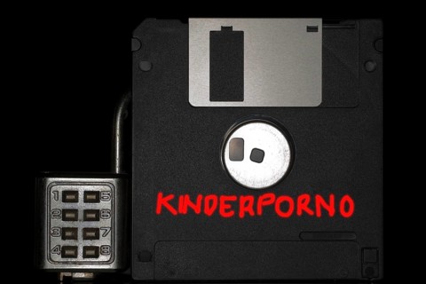Floppy disc with combination lock and the red inscription child porn