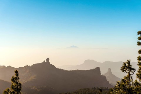 View from the highest peak of Gran Canaria to Roque Nublo peak and volcano El Teide on neighboring island Tenerife