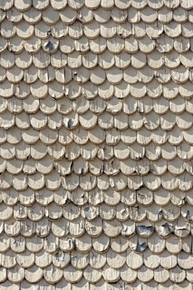 pattern of old wooden shingles with peeling paint