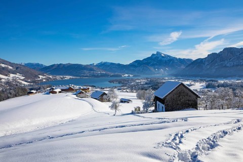 View of snow-covered Mondseeland with Schafberg and Drachenwand