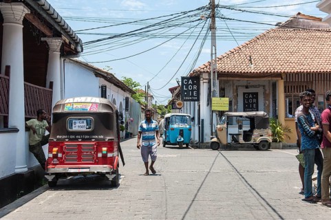 People and tuk tuks in the street