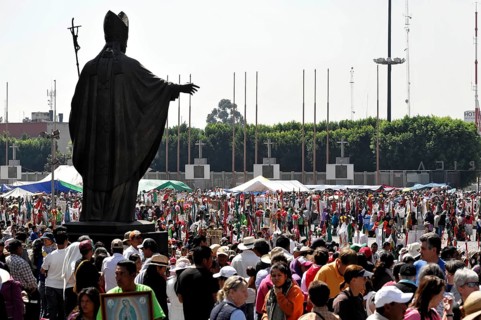 Monument to Pope John Paul II with faithful
