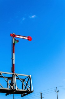 Railway signal against a blue sky
