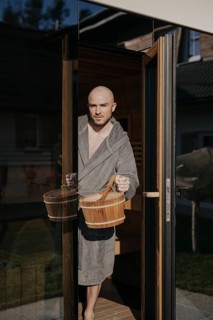 Man with infusion tub in sauna