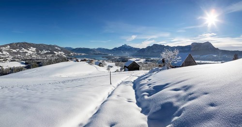 View of snow-covered Mondseeland with Schafberg and Drachenwand