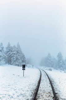 Railway tracks of the Brockenbahn in snowy landscape
