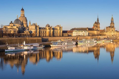 City view with excursion boats in the morning light with reflection in the Elbe