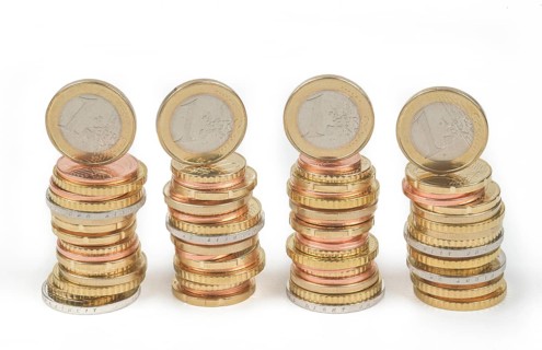 Stack of cent coins and euro coins