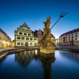 Renaissance houses on the market square with the Neptune Fountain at dawn