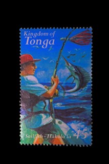 Stamp from the Kingdom of Tonga with a deep-sea angler catching a swordfish as motif