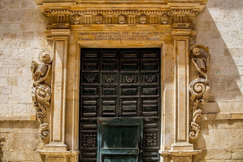 Chiesa del Purgatorio with its portal decorated with skeletons and skulls
