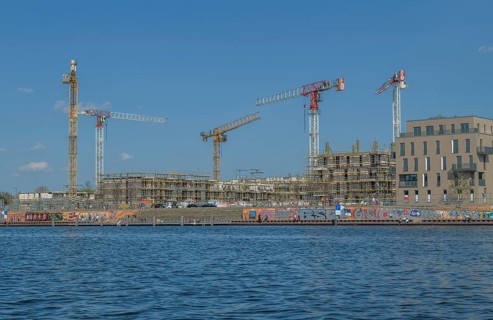 Waterkant development area with building site and construction cranes