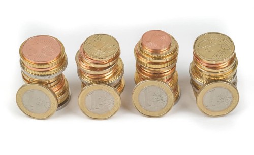 Stack of cent coins and euro coins