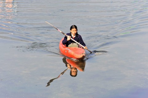 Schoolgirl with paddle boat