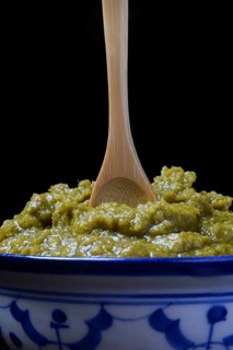 Green Thai curry paste in bowl with wooden spoon
