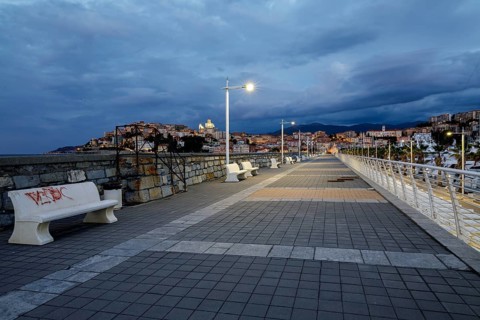 Sunrise with lighthouse at the harbour pier in Porto Maurizio