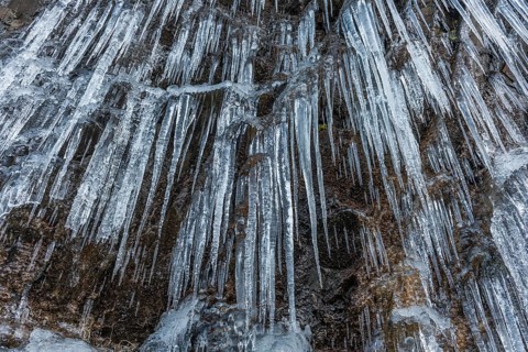 Icicles forming an icefall in the mountain in winter. France
