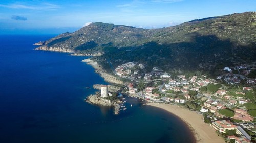 Bird's eye view of the coast of Giglio Campese with the Saracen defence tower Torre del Campese from 1600
