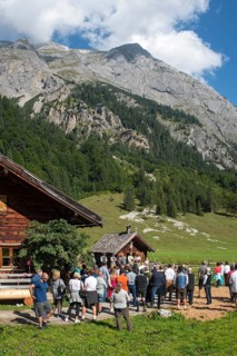 Mass celebration on Almkirtag in front of the wooden chapel in the mountain village of Eng