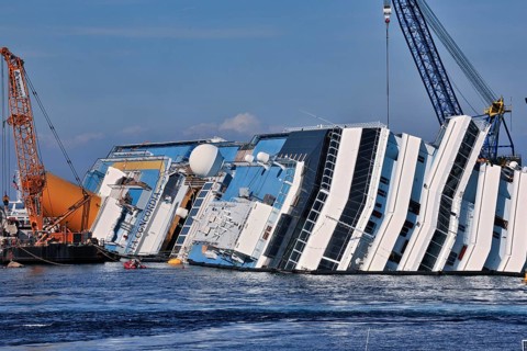 View of the upper deck of the capsized cruise ship with the name Costa Concordia visible