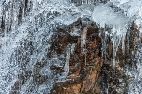Icicles forming an icefall in the mountain in winter. France