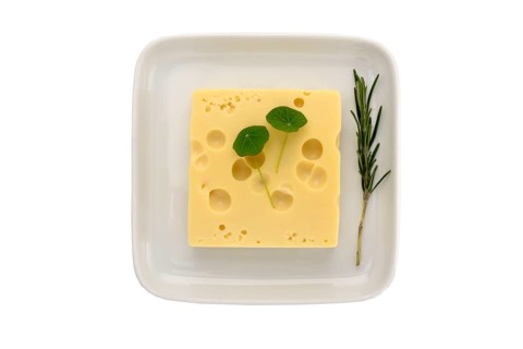 Emmental cheese on a plate with herbs