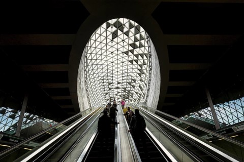 People on escalator with modern skylight