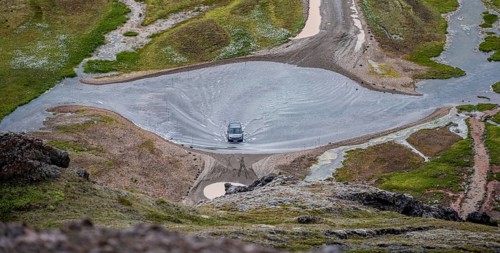 Car drives through ford at Landmannalaugar Camp