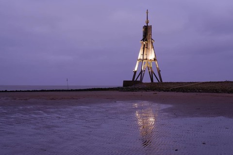 Illuminated Kugelbake at blue hour