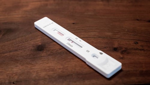Test cassette lies on a wooden table