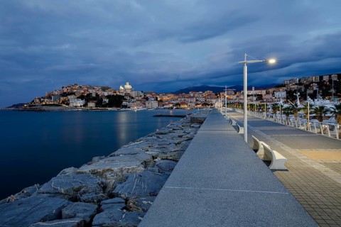 Sunrise with lighthouse at the harbour pier in Porto Maurizio